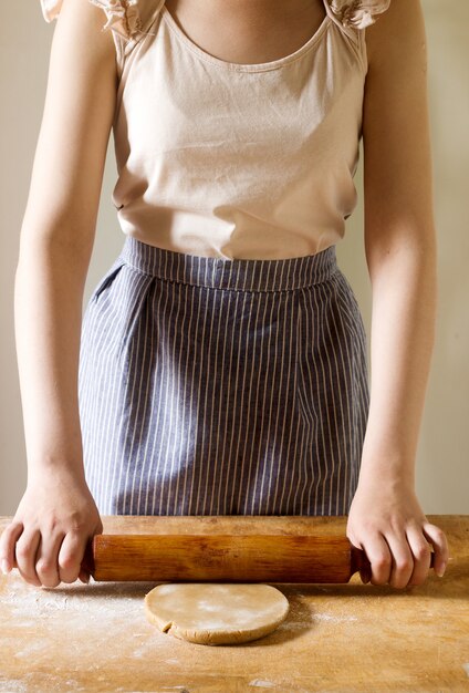 Woman rolling dough for gingerbread.