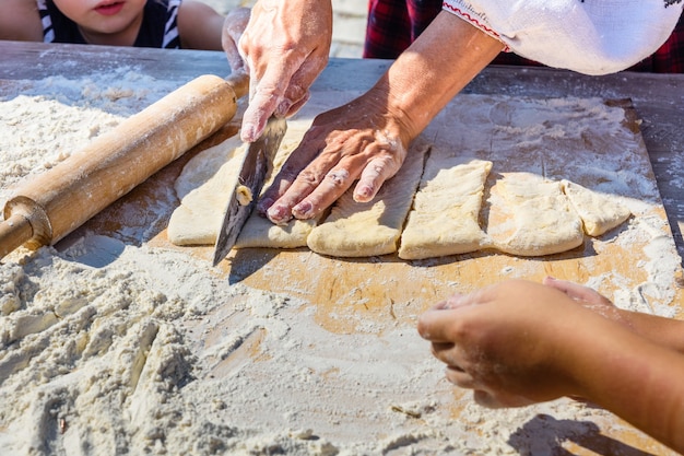 Woman rolling dough with the rolling pin