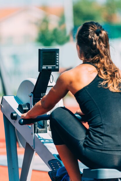 Woman on rowing machine on crossfit competition