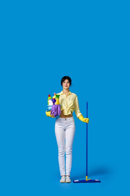 Woman in rubber gloves with cleaning supplies person