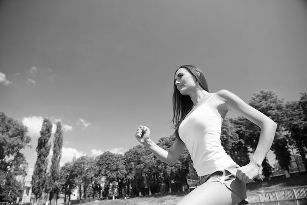 Woman running on arena track