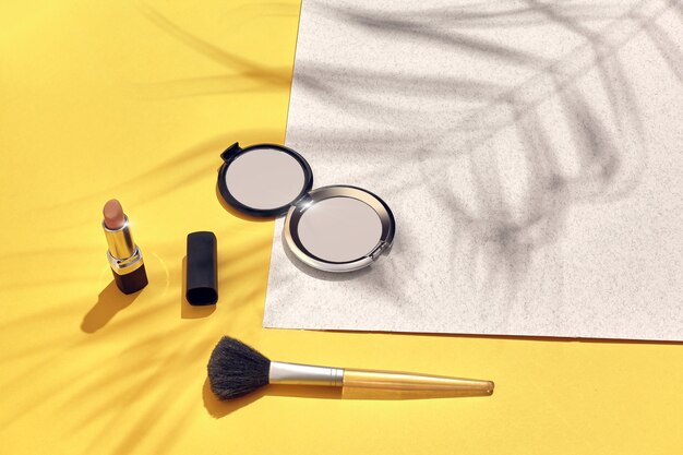 Woman's accessories lying flat on paper background