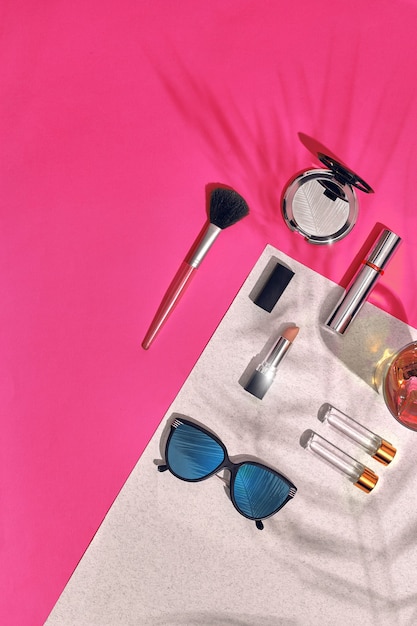 Woman's accessories lying flat on textured paper background