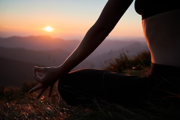 Woman's body in Lotus pose in mountains