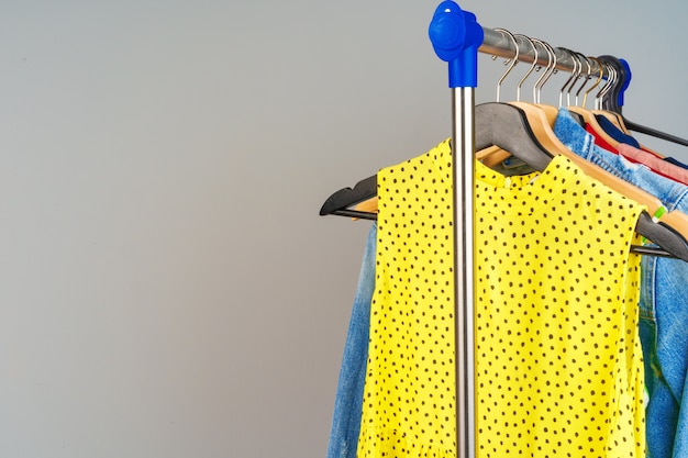 Woman's colorful different clothes on hanger  close up