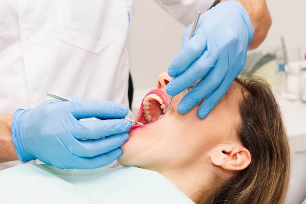 Woman's face with open mouth at a doctor's appointment.