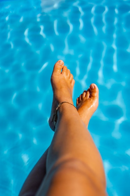 Woman's feet relaxed in swimming pool