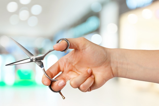 Woman's hand holding scissors