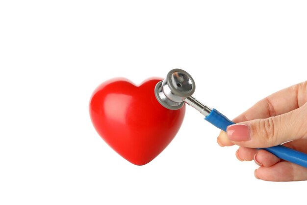 Woman's hand holding a stethoscope near the heart, isolated on white