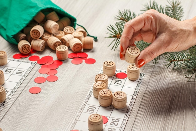 Woman's hand holding a wooden barrel for a game in lotto