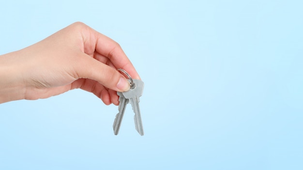 A woman's hand holds a bunch of keys.