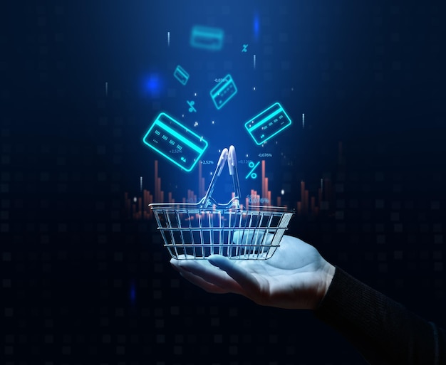 A woman's hand holds a metallic shopping cart and payment card icons the concept of starting a sale high income in retail business