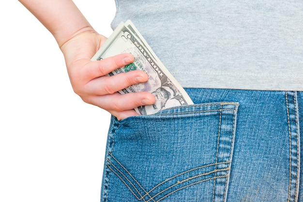 WomanÃ¢ÂÂs hand is putting dollar money in jeans pocket isolated on white background