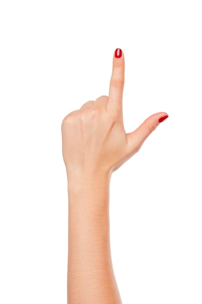 Woman's hand points a finger at something isolated on white 