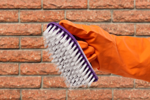 Woman's hand in protective glove with brush