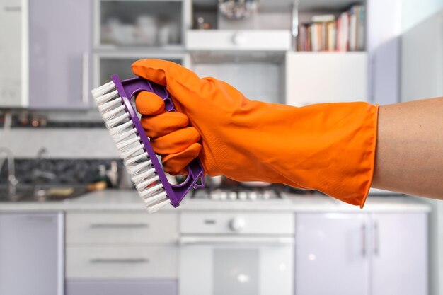 Woman's hand in a protective glove with the brush