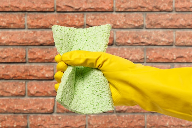 Woman's hand in protective glove with sponge