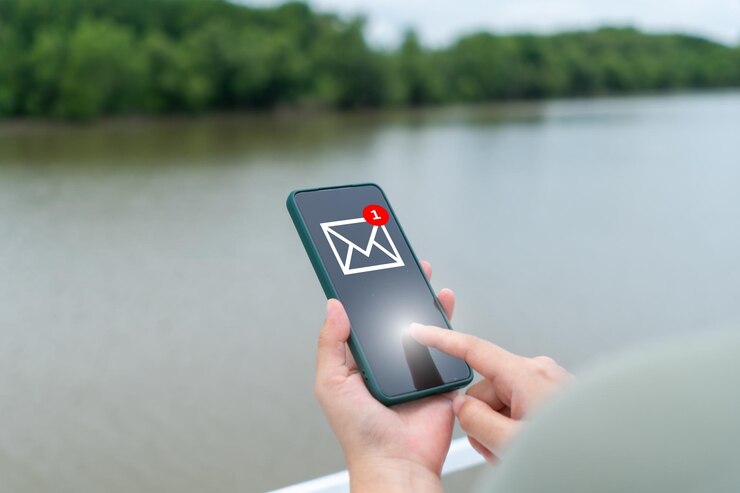 Photo a woman's hand sends and receives emails on her smartphone concept of business communication technology