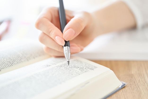 Woman's hand studying with text