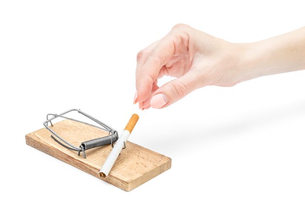 Woman's hand taking cigarette from mousetrap on white background