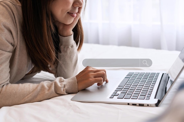 Woman\'s hand using a computer notebook to searching for\
information data search technology search engine optimization\
searching browsing internet data information concept