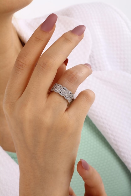 A woman's hand with a diamond ring on it