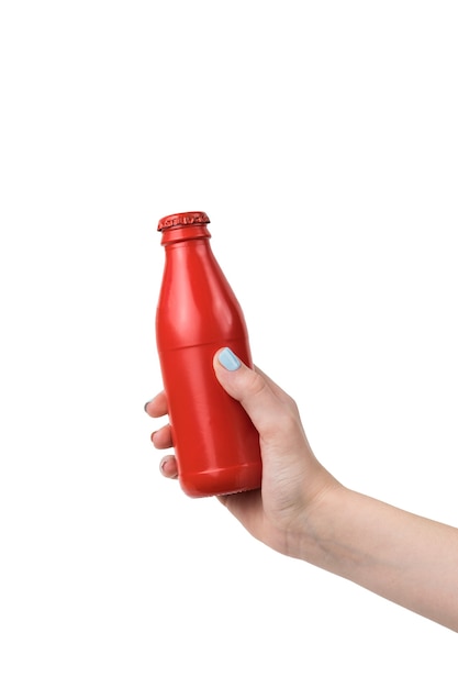 A woman's hand with a red glass closed bottle isolated on a white surface