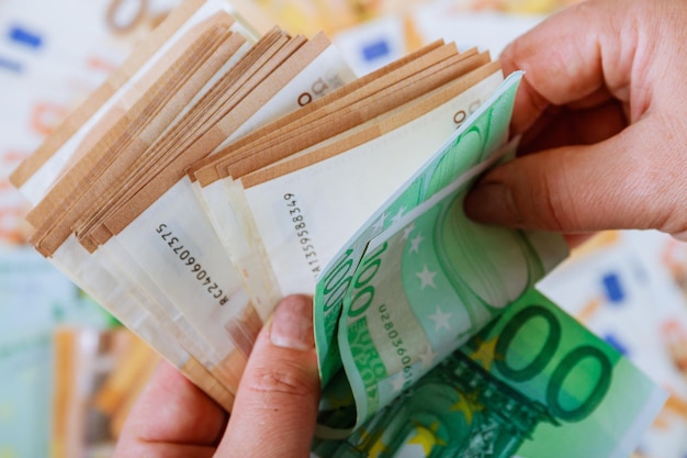 Photo woman's hands are counting euro banknotes on a background of euro banknotes spend money