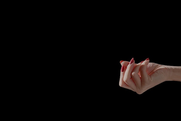 Woman's hands are touching their fingers against a black background