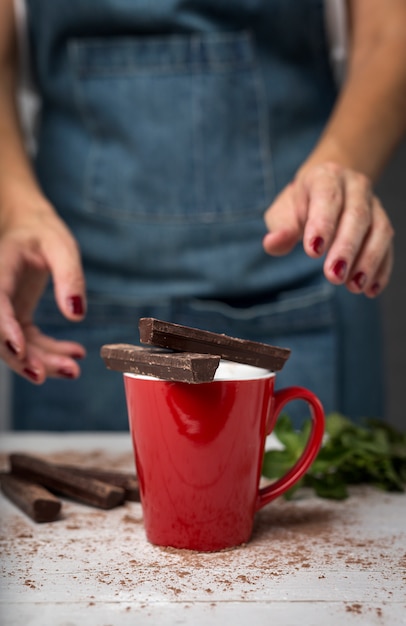 Woman's hands close up holding a cup of chocolate