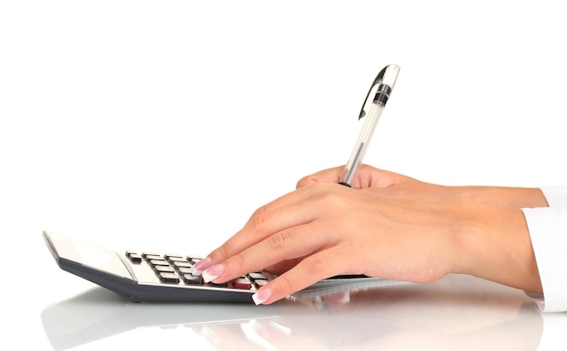 Photo woman's hands counts on the calculator on white background closeup