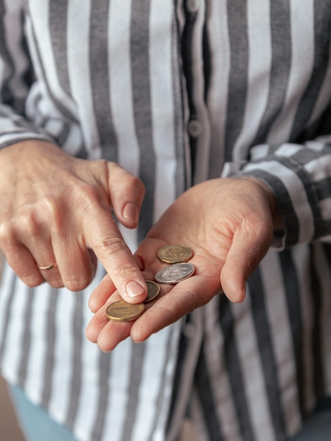 Woman's hands hold and count coins of Russian rubles