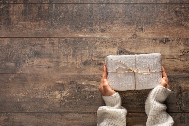 Woman's hands holding a Christmas gift