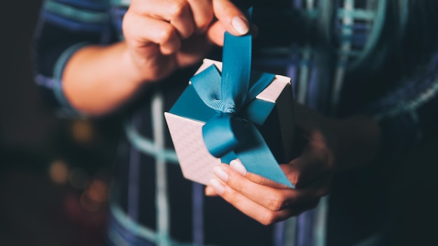 Woman's hands holding a Christmas gift