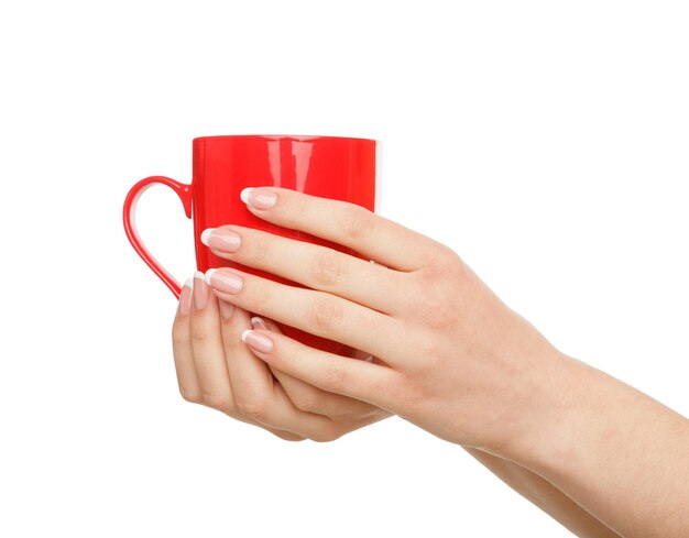 Woman's hands holding red mug with hot drink isolated on white background, close-up, cutout