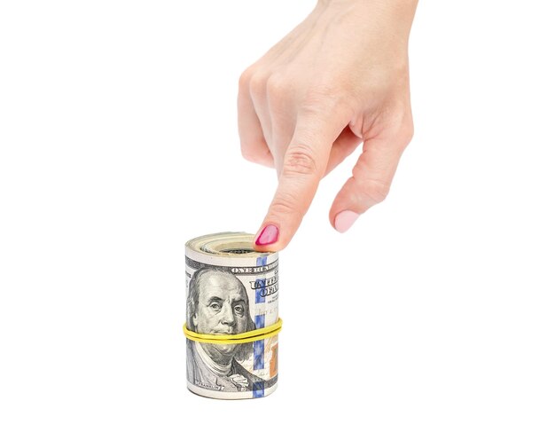 Woman's hands holding rolled up dollar bills Isolated on white