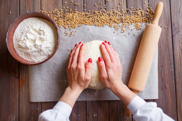 Woman's hands knead dough