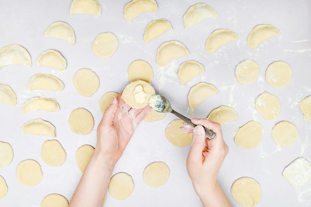 Woman's hands make ravioli