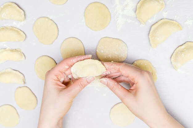 Woman's hands makes ravioli