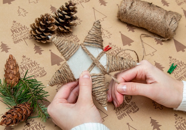 Woman's hands making a Christmas ornament