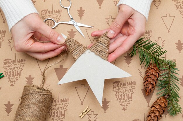 Woman's hands making a Christmas ornament