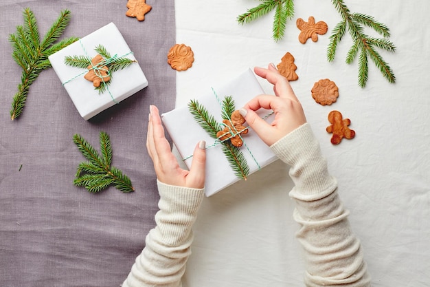 Woman's hands packing Christmas gift