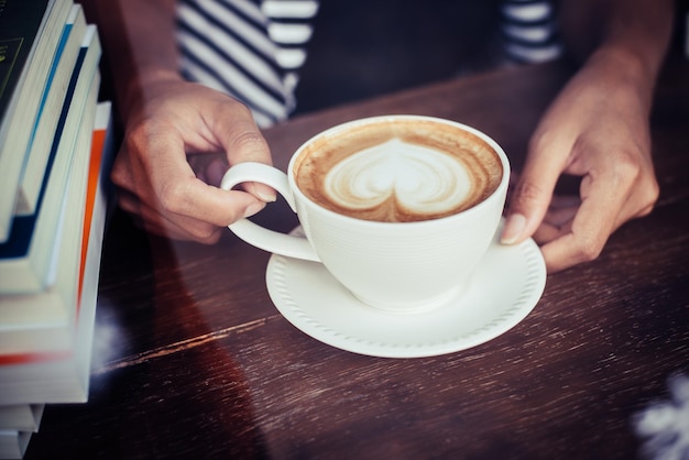 Woman's hands relaxing with coffee at cafe Women lifestyle concept