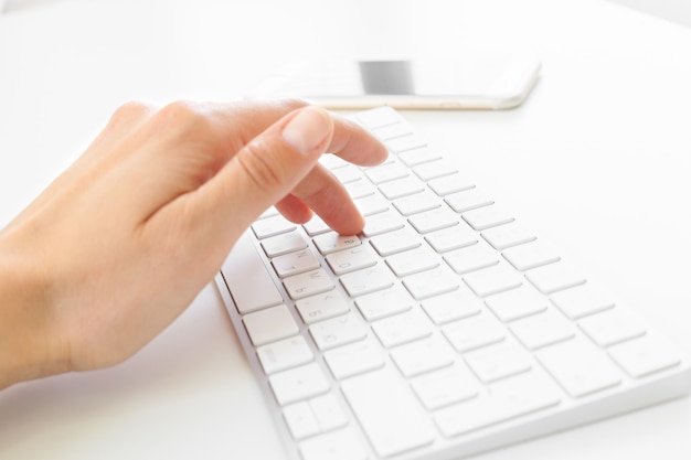 Woman's hands using keyboard at the office