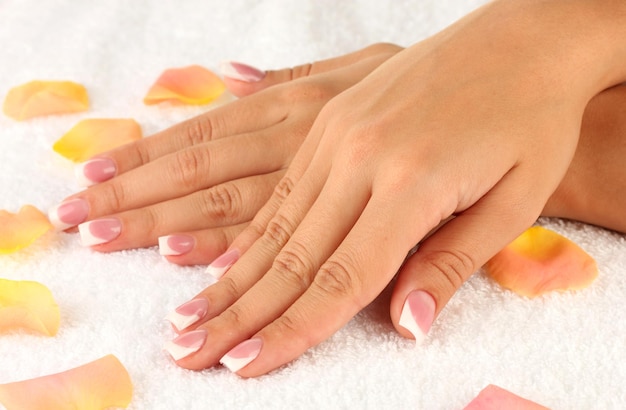 Woman's hands on white terry towel closeup