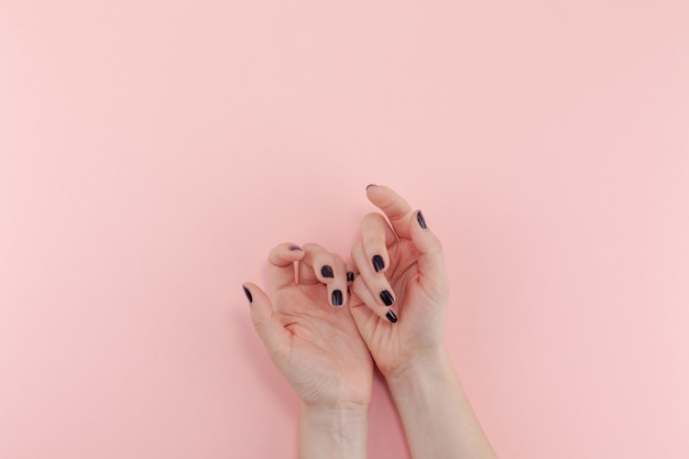 Woman's hands with black manicure