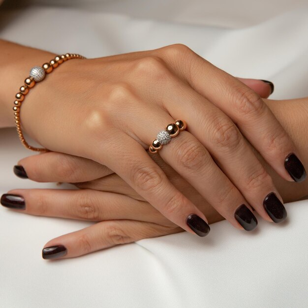 A woman's hands with a ring on the left hand and a bracelet on the right hand.