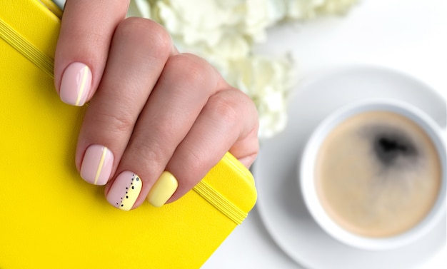 Woman's hands with spring summer nail design