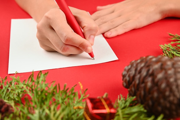 Woman's hands writing a letter for Christmas