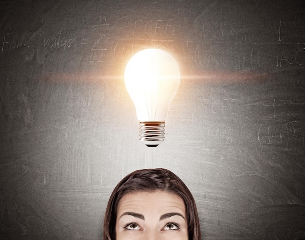 Woman's head and a giant light bulb